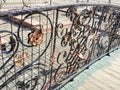 Forged bridge for lovers with wedding locks in the shape of a heart. Royalty Free Stock Photo