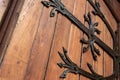 Forged door pattern, decorative. Old vintage entrance, massive heavy wooden door of church or cathedral Royalty Free Stock Photo