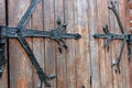 Forged door pattern, decorative. Old vintage entrance, massive heavy wooden door of church or cathedral