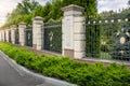 Forged fence painted with gold at entrance to luxury villa Royalty Free Stock Photo