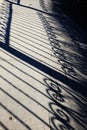 Forged fence shadow on an track Royalty Free Stock Photo