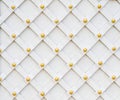 Forged gate background, grille with gold rivets, painted white color Royalty Free Stock Photo