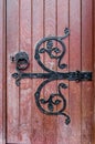 Forged hinge on ancient wooden door Royalty Free Stock Photo