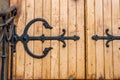 Forged hinge on ancient wooden door Royalty Free Stock Photo