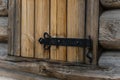Forged hinge on the wooden shutter close up. ancient Russian architecture Royalty Free Stock Photo