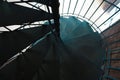 Forged iron twisted stairs with reflection on a red brick wall Royalty Free Stock Photo