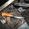Forged knife on workbench in turnery workshop