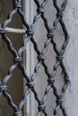 Forged lattice structure as a screen or fence for window protection in old monastery.