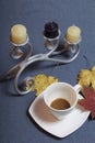 Forged metal candlestick with candles. A cup with unapproved coffee. Fallen autumn leaves of yellow and red are scattered on the s Royalty Free Stock Photo