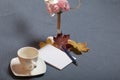 Forged metal candlestick with candles. There is an open notepad and a pen. A cup with unapproved coffee. Fallen autumn leaves of y Royalty Free Stock Photo