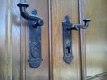 Forged metal door handles with a lock in a vintage design. The lock in the church door or in the door of the old house Royalty Free Stock Photo