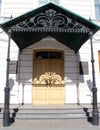 Old mansion, porch, forged visor, shadow, house, urban architecture and design. Royalty Free Stock Photo