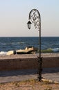Forged park street lantern on the beach with a boats