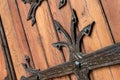 Forged pattern on door with decorative elements. Old vintage entrance, massive heavy wooden door of church or cathedral