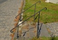 Forged railing made of black solid metal is the work of a skilled craftsman and his workshop. twisted ends of the handle. There ar