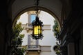 Forged street lamp with yellow glass. Royalty Free Stock Photo