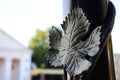 Forged wedge-shaped leaf on a lamppost close-up against a blurred background.