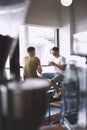 Forget about everything else and go for coffee. two young men talking while having coffee together in a cafe. Royalty Free Stock Photo