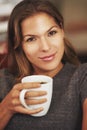 Forget love, fall in coffee. Portrait of a young woman enjoying a cup of coffee at home.