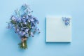 Forget me not flowers bouquet on blue pastel background