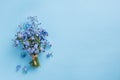 Forget me not flowers bouquet on blue pastel background