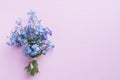 Forget me not flowers bouquet on pink pastel background