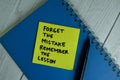 Forget The Mistake Remember The Lesson write on sticky notes isolated on office desk Royalty Free Stock Photo