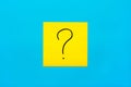 Forget, reminder, combination of colour concept- Close up black handwritten symbol of question mark on one yellow square sticker Royalty Free Stock Photo