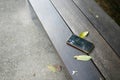 forget smartphone on a park bench, lost smart phone Royalty Free Stock Photo