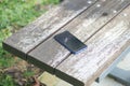 forget smartphone on a park bench, lost smart phone Royalty Free Stock Photo