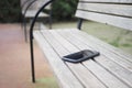 forget smartphone on a park bench, lost smart phone Royalty Free Stock Photo