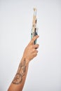 Forget your worries and grab a brush. an unrecognizable woman holding paintbrushes against a white background.