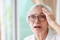 Forgetful asian senior woman with amnesia,brain disease,patient holding head with her hand,suffering from senile dementia,memory