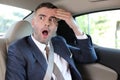 Forgetful businessman feeling panic in taxi Royalty Free Stock Photo