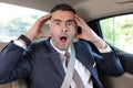 Forgetful businessman feeling panic in taxi Royalty Free Stock Photo