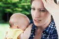 Forgetful Mother Holding Baby Girl At Home Royalty Free Stock Photo