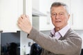 Forgetful Senior Man Looking In Cupboard Royalty Free Stock Photo