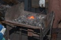 A Forging Furnace: Blacksmith Working Iron and Incandescent Charcoal