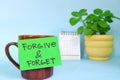 Forgive and forget motivation and inspiration forgiveness message concept. Selective focus of a cup of coffee Royalty Free Stock Photo