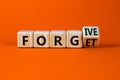 Forgive and forget symbol. Turned a wooden cube and changed the word forgive to forget. Beautiful orange background, copy space.
