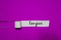 Forgive, Inspiration, Motivation and business concept on purple torn paper