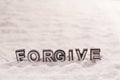 Forgive word on white sand Royalty Free Stock Photo