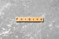 Forgive word written on wood block. Forgive text on cement table for your desing, Top view concept