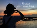 Forgiveness inspirational quote - Forgive every single thing. With young woman silhouette making heart love sign at sunset.