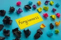 Forgiveness word about relationship and paper balls.