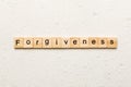 forgiveness word written on wood block. forgiveness text on table, concept