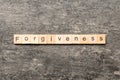 forgiveness word written on wood block. forgiveness text on table, concept Royalty Free Stock Photo