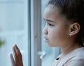 A forgotten child should be a punishable offence. Shot of a little girl starting out of the window looking sad at home. Royalty Free Stock Photo