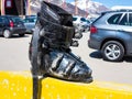 Forgotten dirty mountain ski boot on the parking