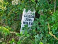 A forgotten distance marker in undergrowth on the Leeds to Liverpool Canal in Lancashire in the UK